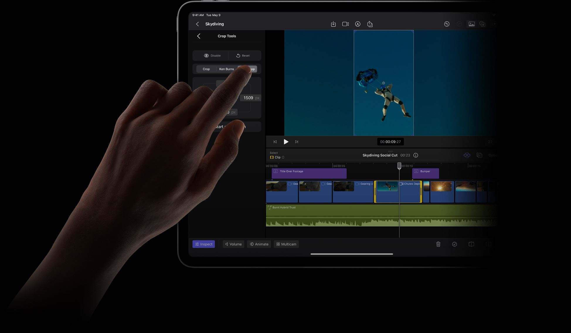 Finger touching iPad Pro display to select an item from the Crop Tools menu in Final Cut Pro.