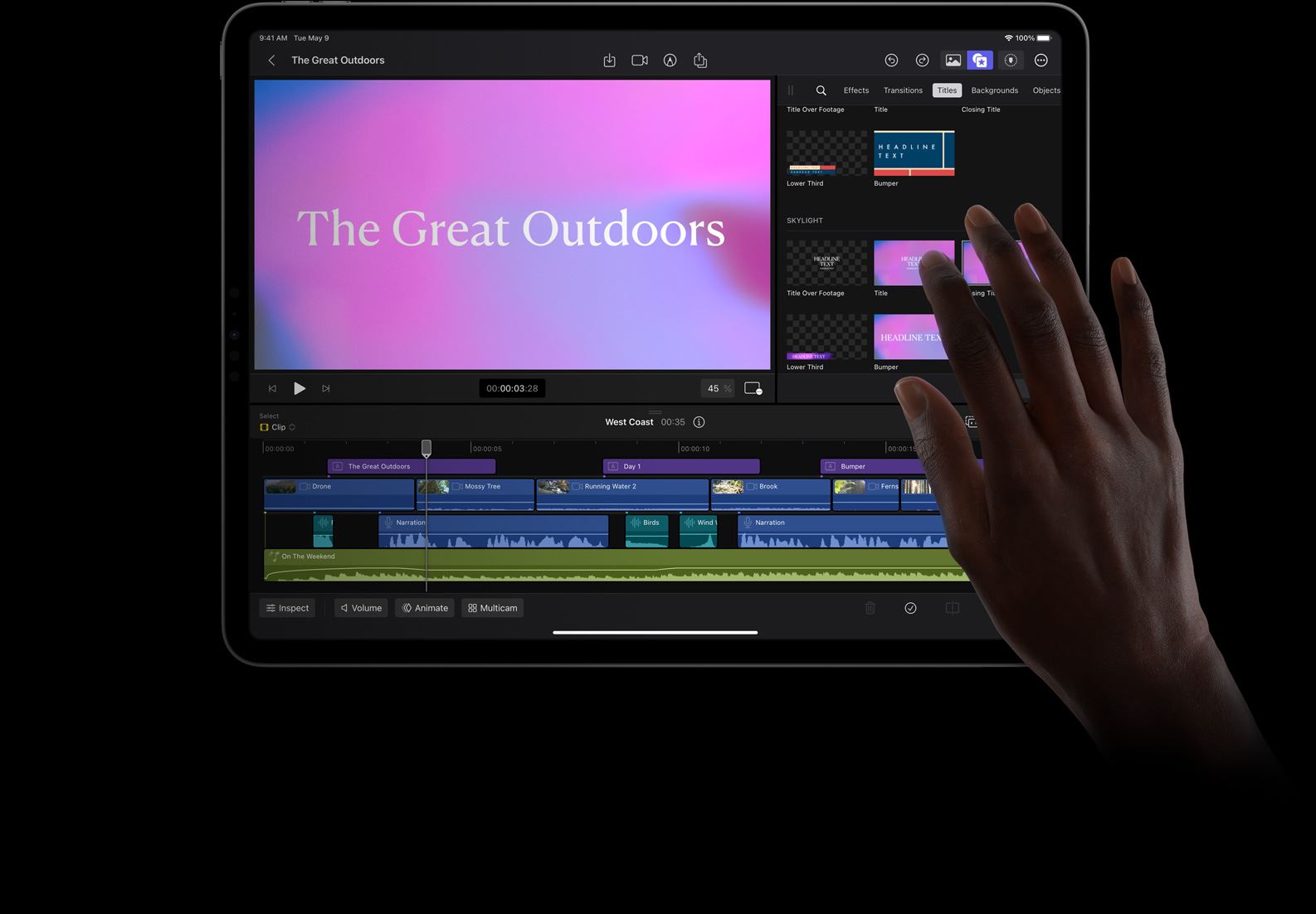 Hand with finger selecting pink and blue background for title treatment in Final Cut Pro for iPad on iPad Pro.