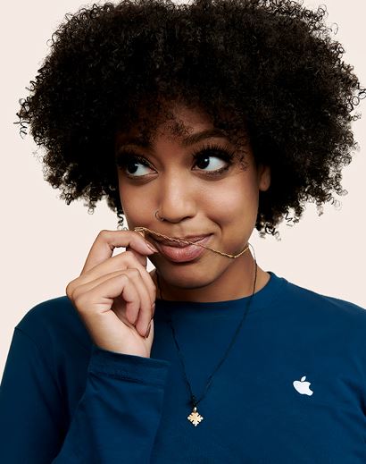 Apple Retail employee with her hand raised to her mouth.
